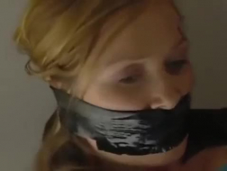 Hot woman taped and filmed by perv while kneeling on the floor.