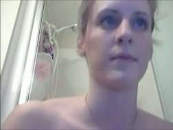 Blue eyed blonde with a huge smile is posing naked in front of her web camera