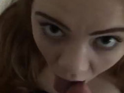 Sexy redhead is sucking a slutty teen's big, pink dildo in a hotel room, during the day