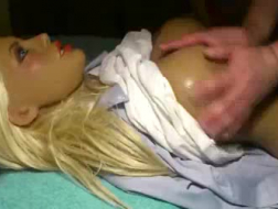 Blonde doll is playing with her toes and playing with her tits, at the same time.